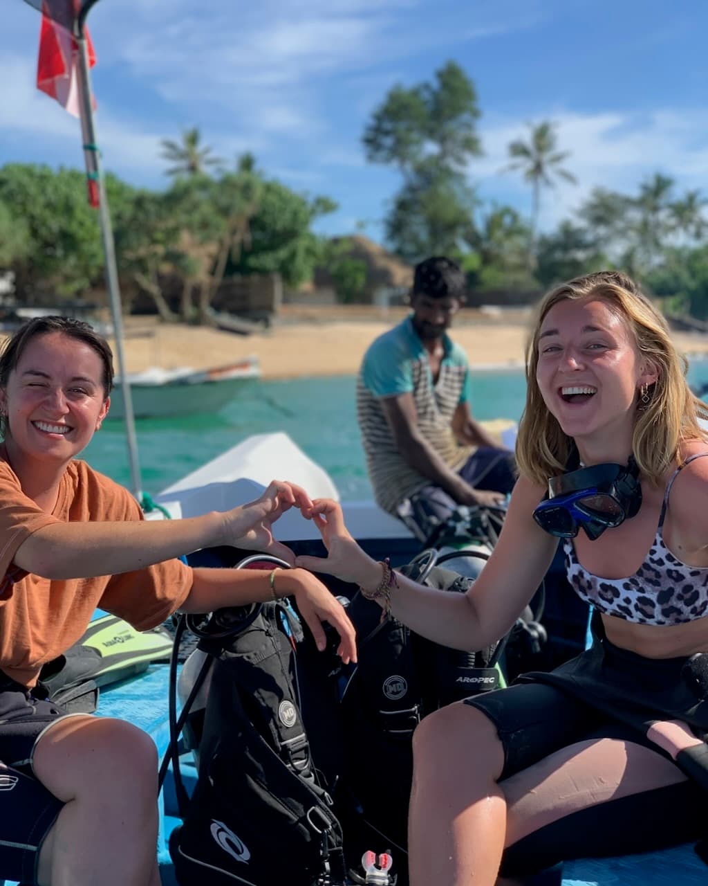 Two guests making a heart shape with their hands in Mirissa